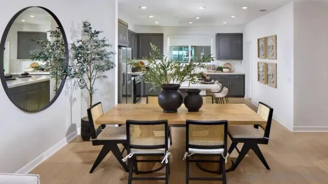 a view of a dining room with furniture and a potted plant