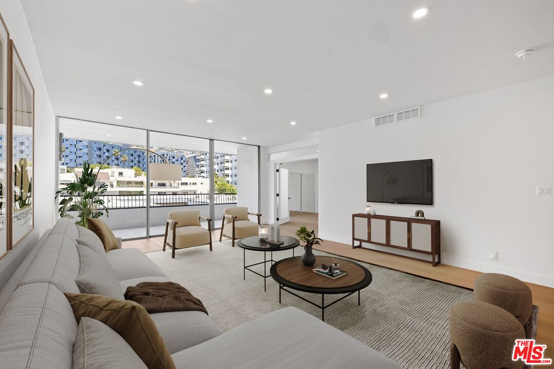 1100 Alta Loma Road, Unit 902 West Hollywood, CA 90069 - Photo 2 of 17 a living room with furniture and a flat screen tv
