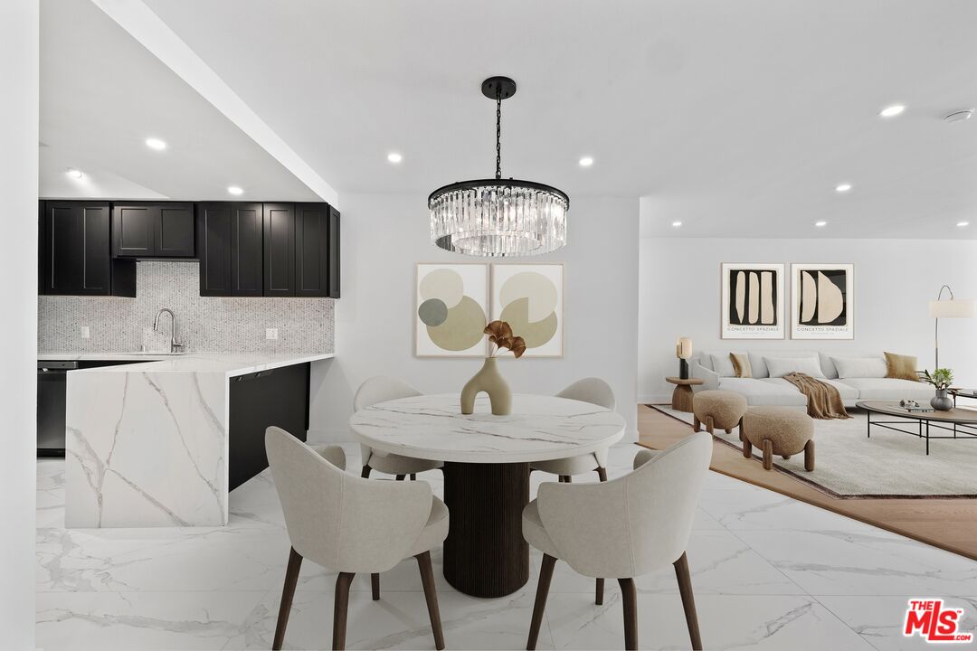 1100 Alta Loma Road, Unit 902 West Hollywood, CA 90069 - Photo 3 of 17 a living room with fireplace furniture and a kitchen view