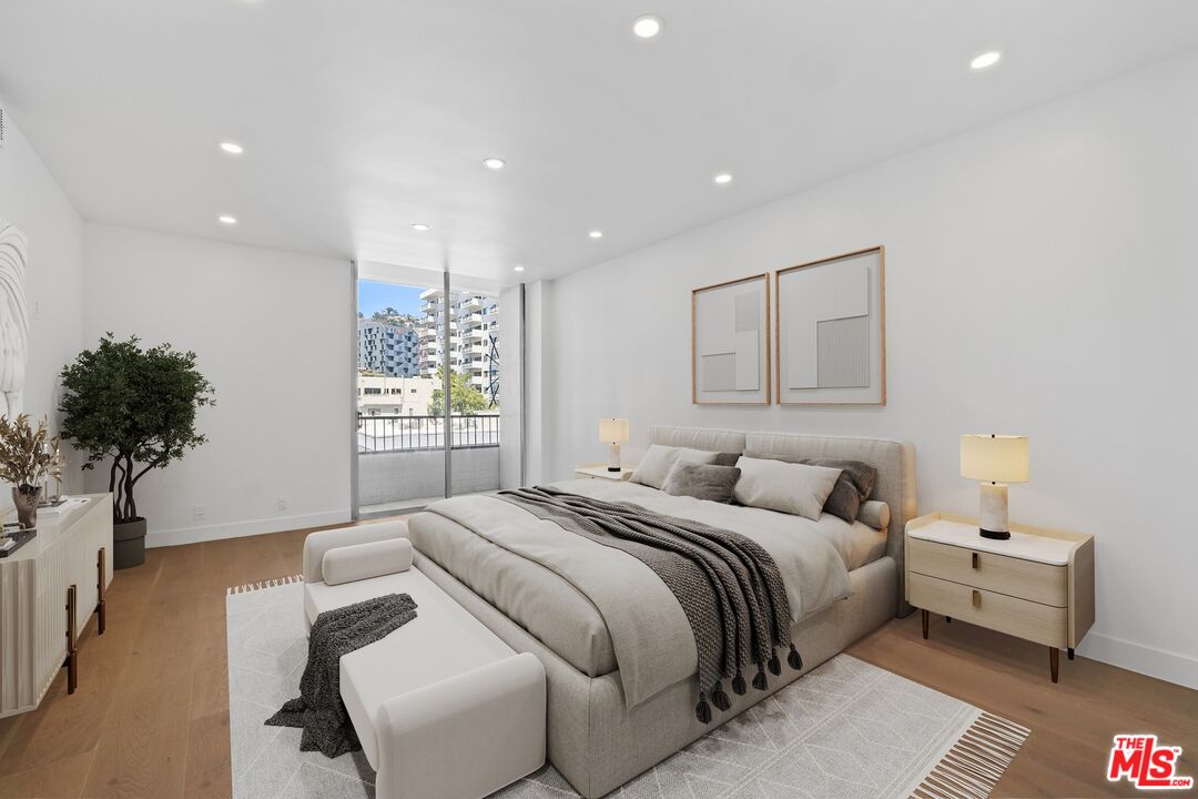 1100 Alta Loma Road, Unit 902 West Hollywood, CA 90069 - Photo 5 of 17 a bedroom with a bed and a potted plant