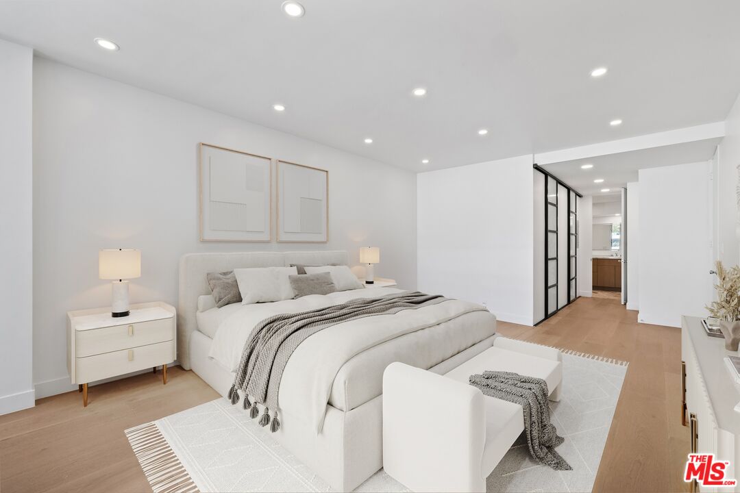 1100 Alta Loma Road, Unit 902 West Hollywood, CA 90069 - Photo 6 of 17 a spacious bedroom with a bed and a couch