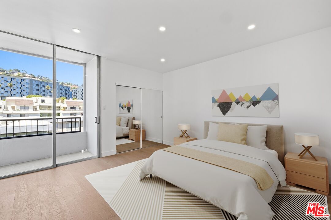1100 Alta Loma Road, Unit 902 West Hollywood, CA 90069 - Photo 9 of 17 a bedroom with a large bed and a large window