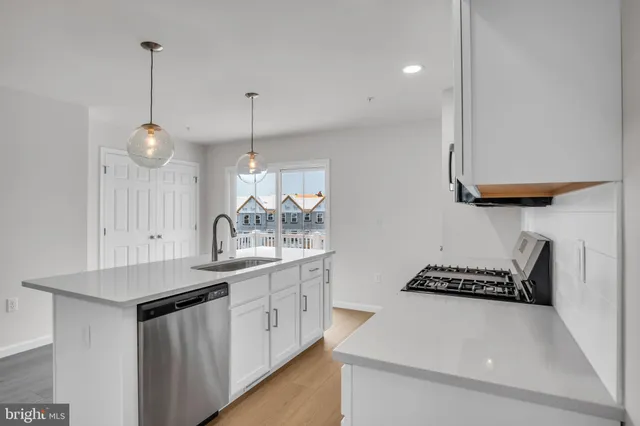 a kitchen with sink and cabinets