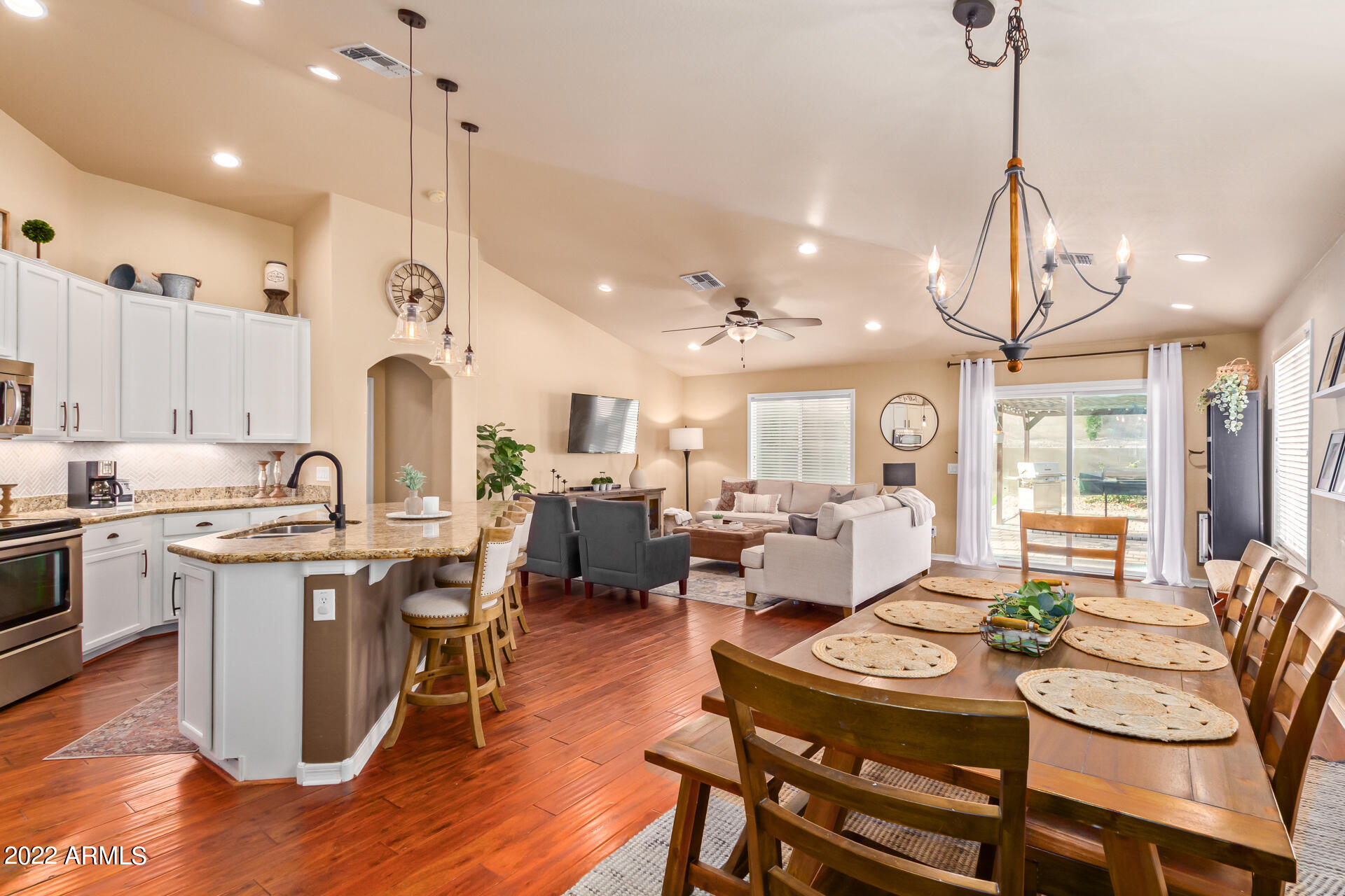 20748 West White Rock Road Buckeye, AZ 85396 - Photo 11 of 34 a very nice looking open dining room with kitchen island stainless steel appliances a dining table and chairs