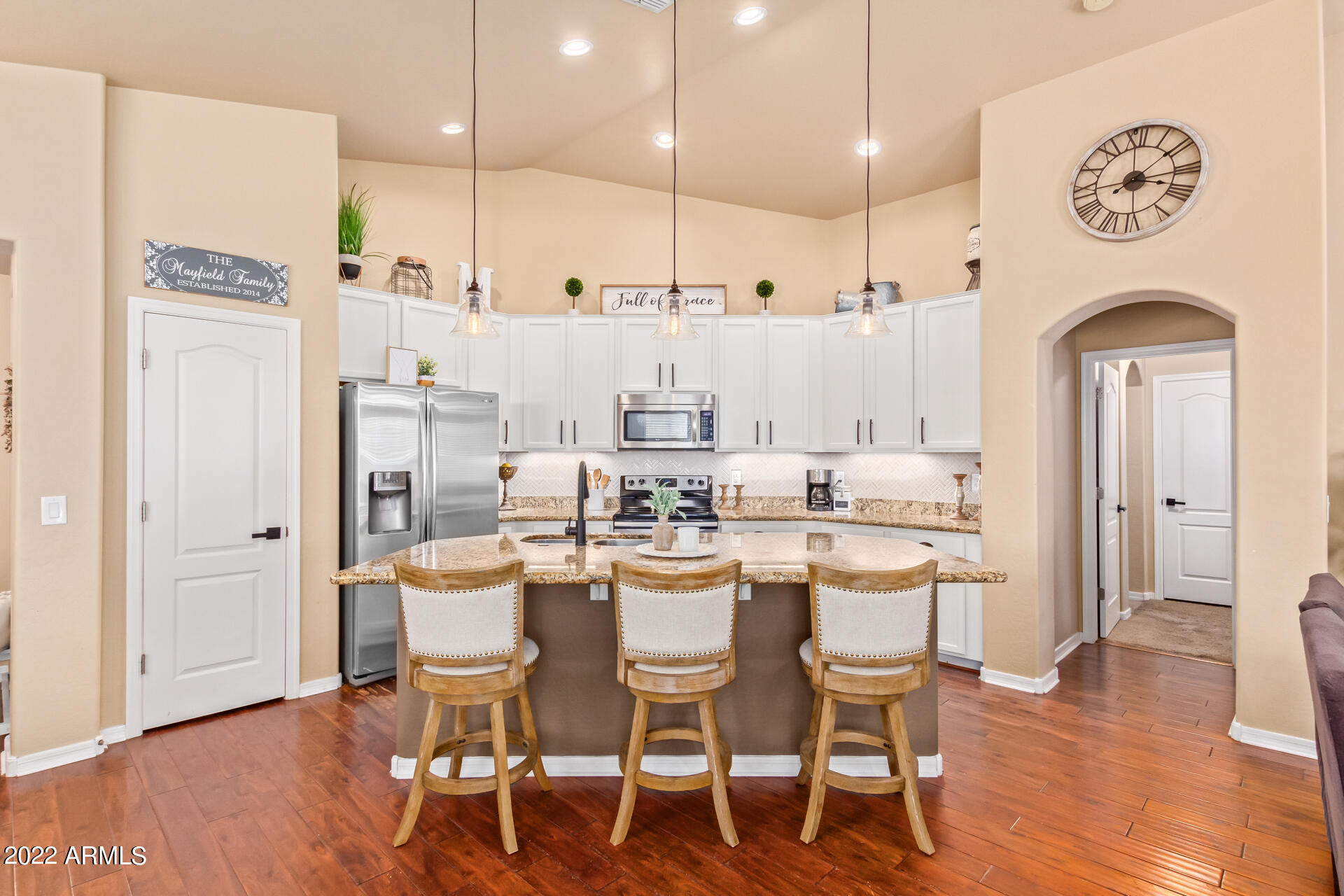 20748 West White Rock Road Buckeye, AZ 85396 - Photo 12 of 34 a dining area with stainless steel appliances kitchen island granite countertop a dining table chairs and a refrigerator