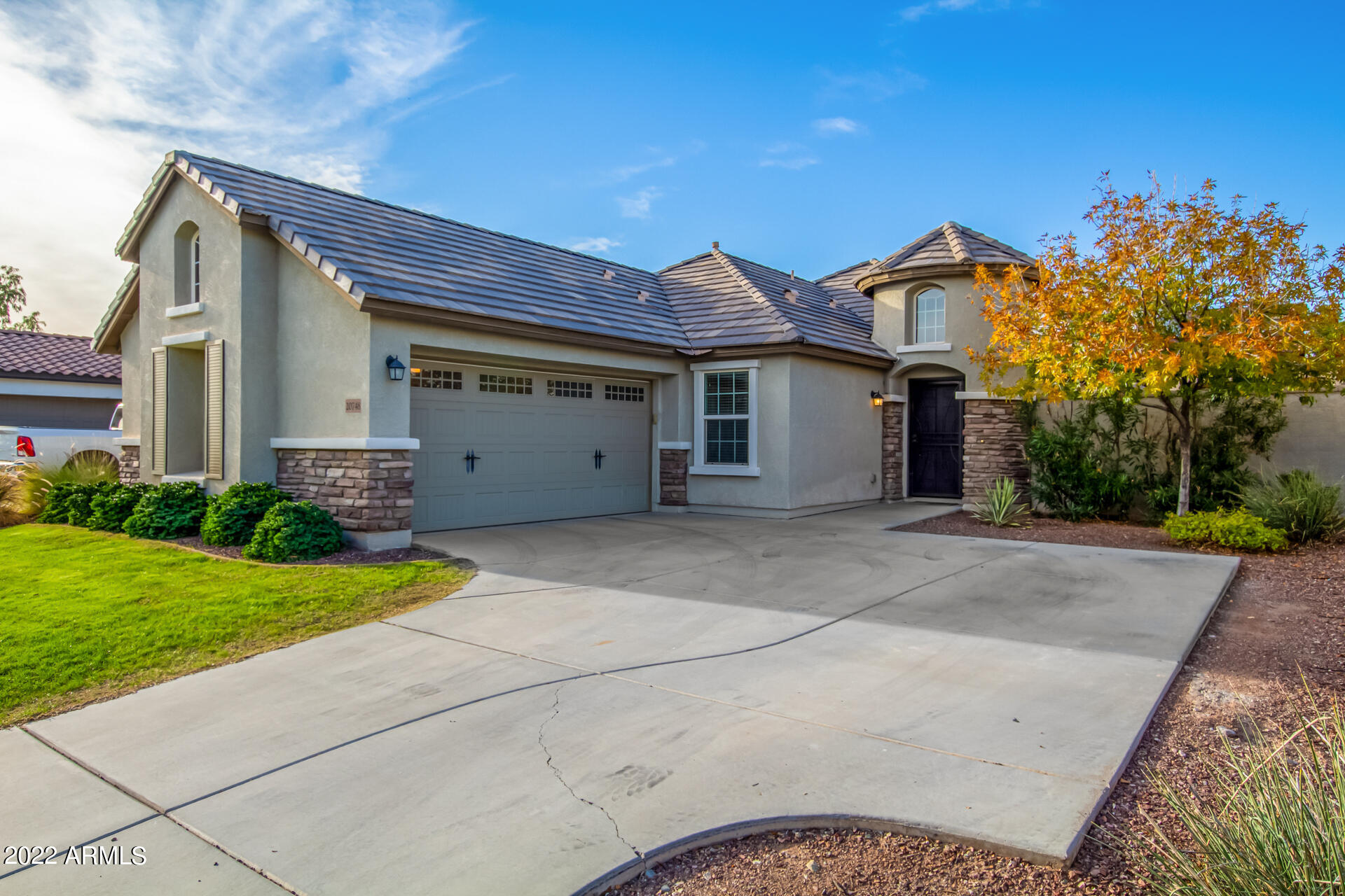 20748 West White Rock Road Buckeye, AZ 85396 - Photo 2 of 34 a view of a house with a yard and a large tree