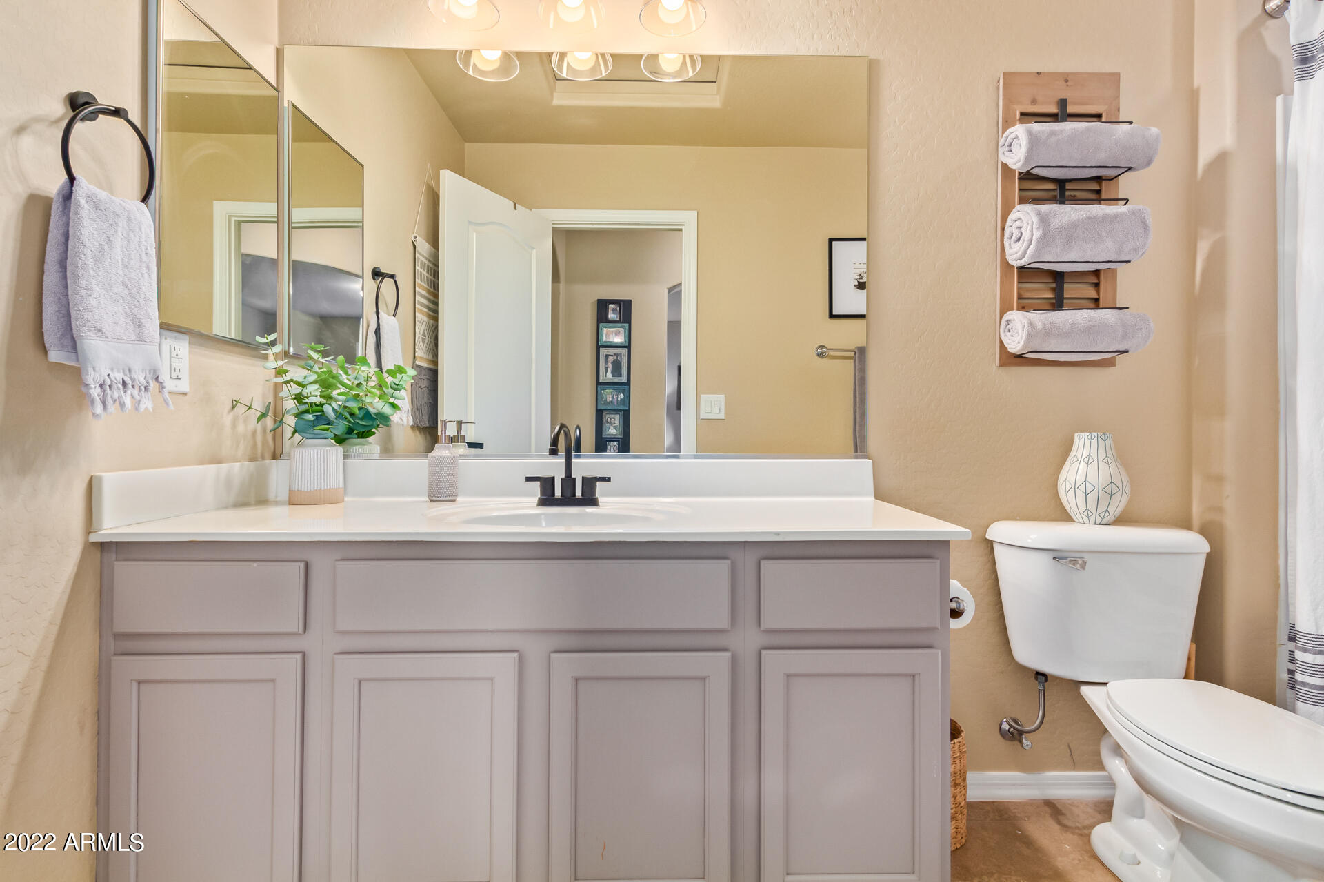 20748 West White Rock Road Buckeye, AZ 85396 - Photo 25 of 34 a bathroom with a toilet sink and mirror