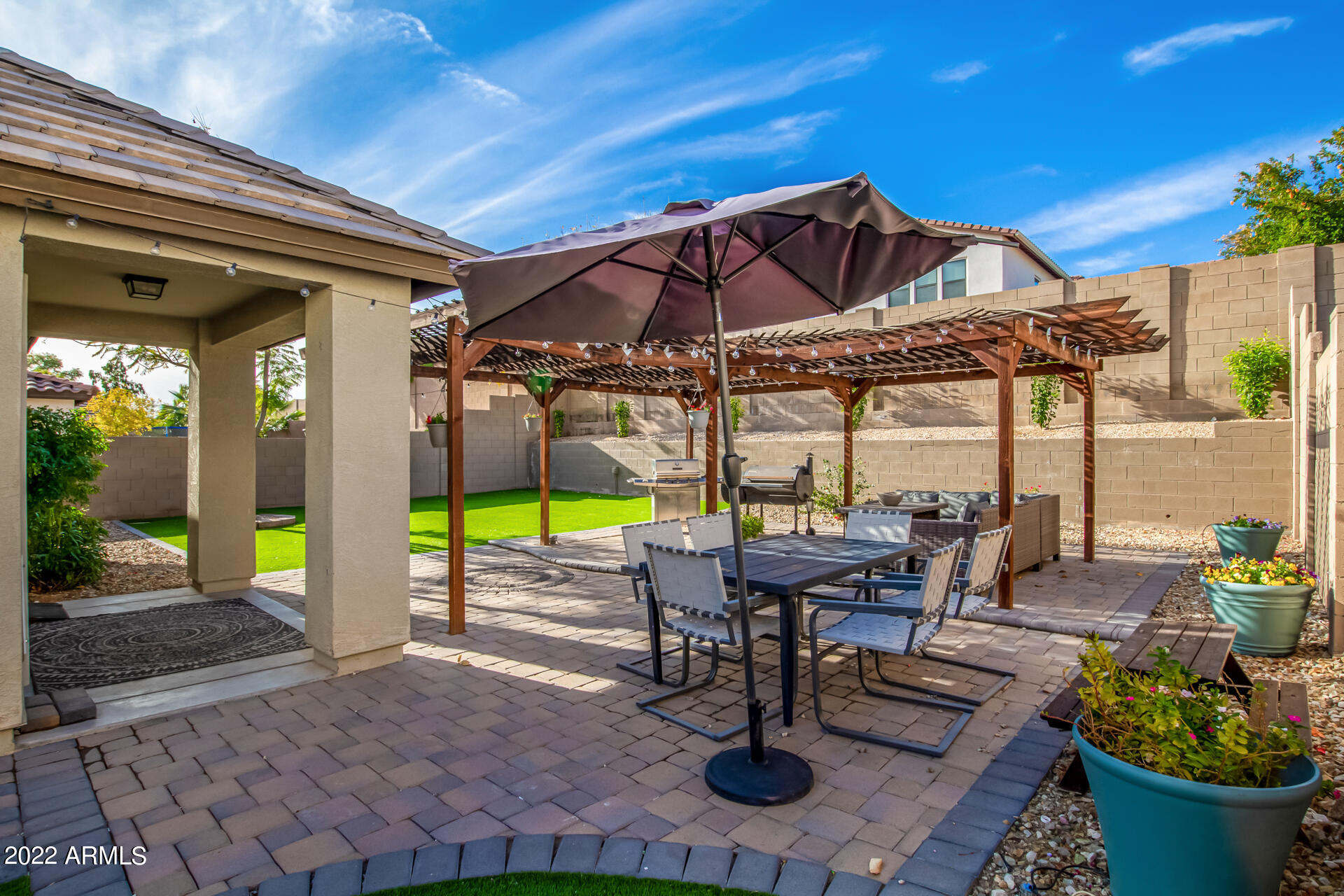 20748 West White Rock Road Buckeye, AZ 85396 - Photo 29 of 34 a view of a patio with table and chairs potted plants