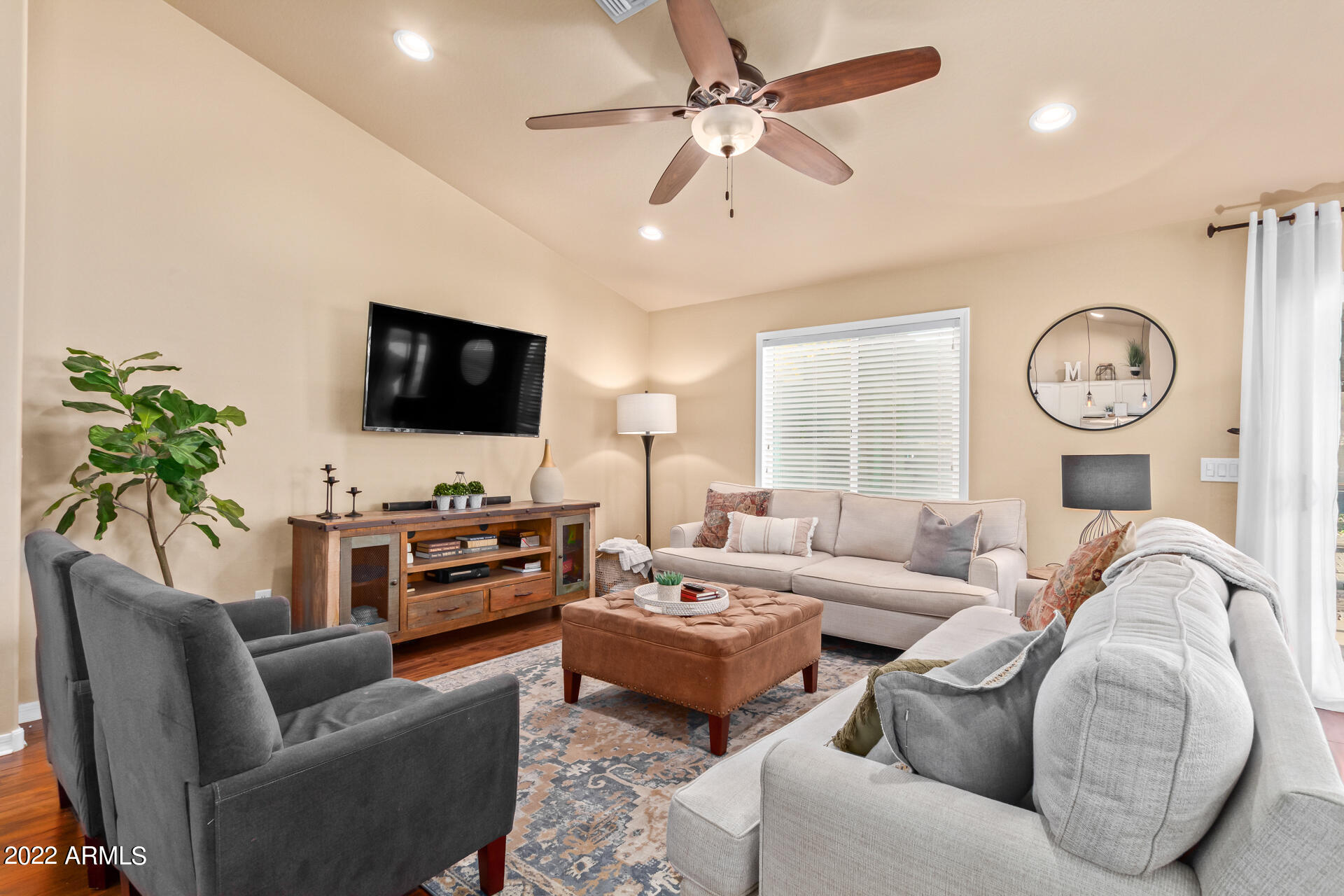 20748 West White Rock Road Buckeye, AZ 85396 - Photo 5 of 34 a living room with furniture a flat screen tv and a window