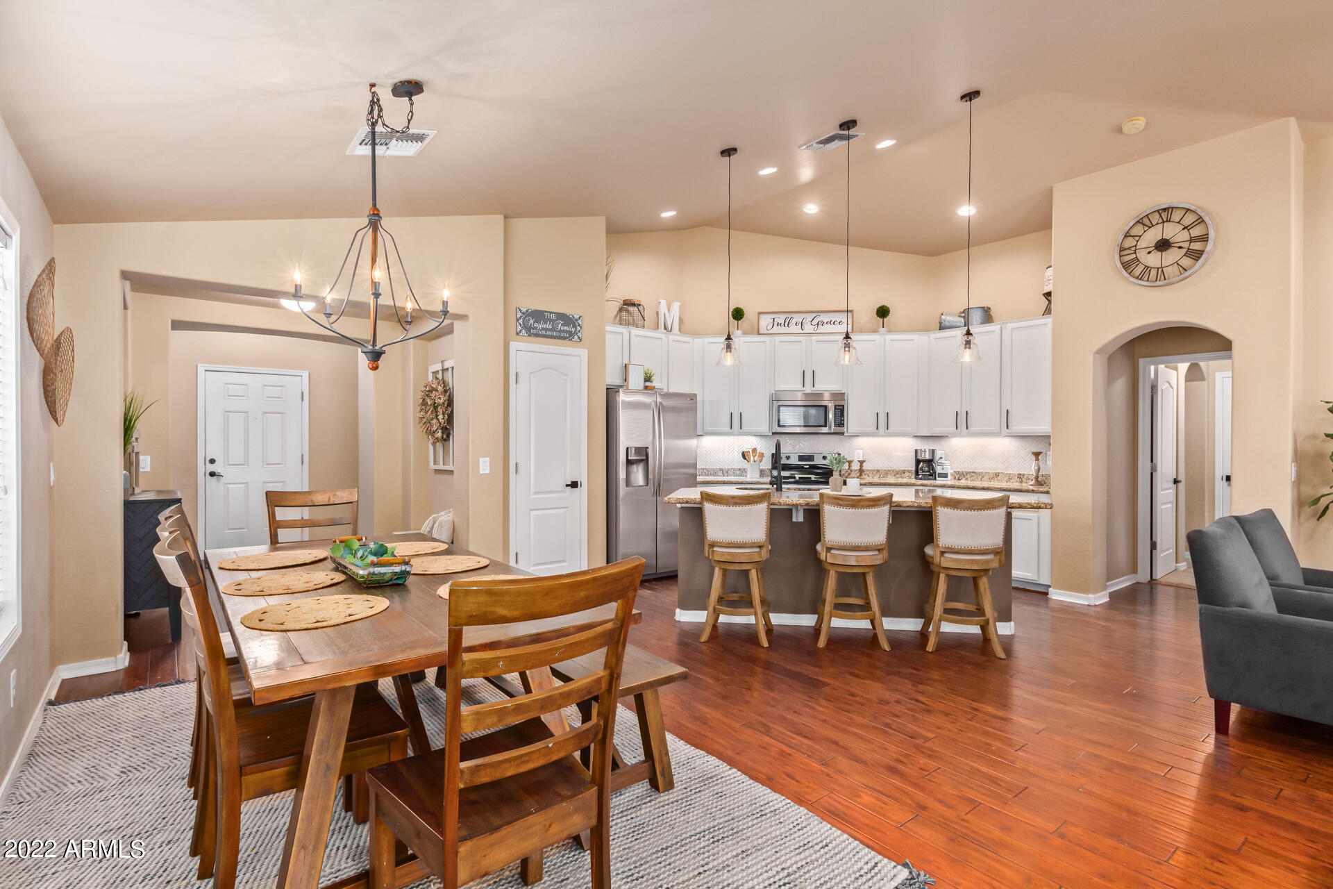 20748 West White Rock Road Buckeye, AZ 85396 - Photo 10 of 34 a view of a dining room and livingroom with furniture wooden floor a chandelier