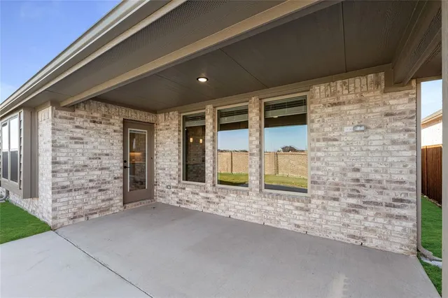 a front view of a house with a garden and yard