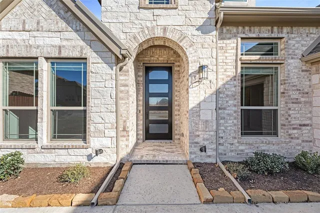 a front view of a house with large windows