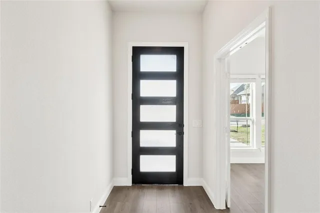 a view of an entryway with wooden floor
