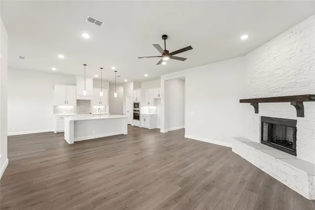 a view of kitchen with kitchen island wooden floor center island and appliances