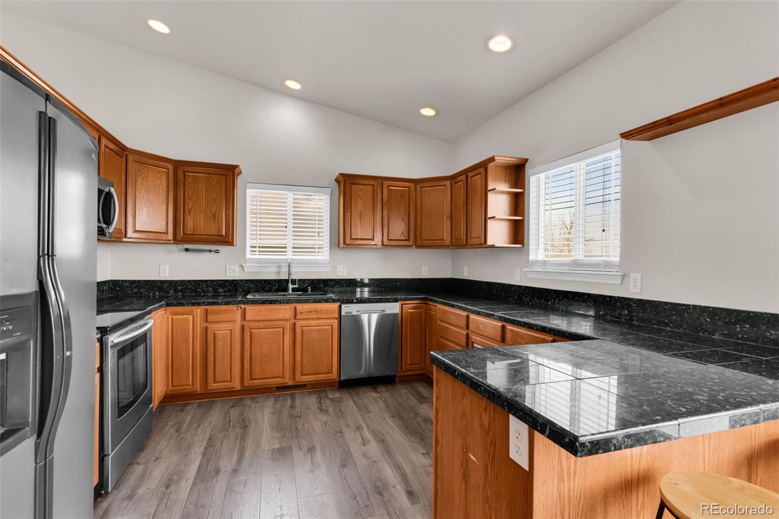 249 High Meadows Drive Florence, CO 81226 - Photo 11 of 47 a kitchen with stainless steel appliances granite countertop wooden cabinets a sink and dishwasher