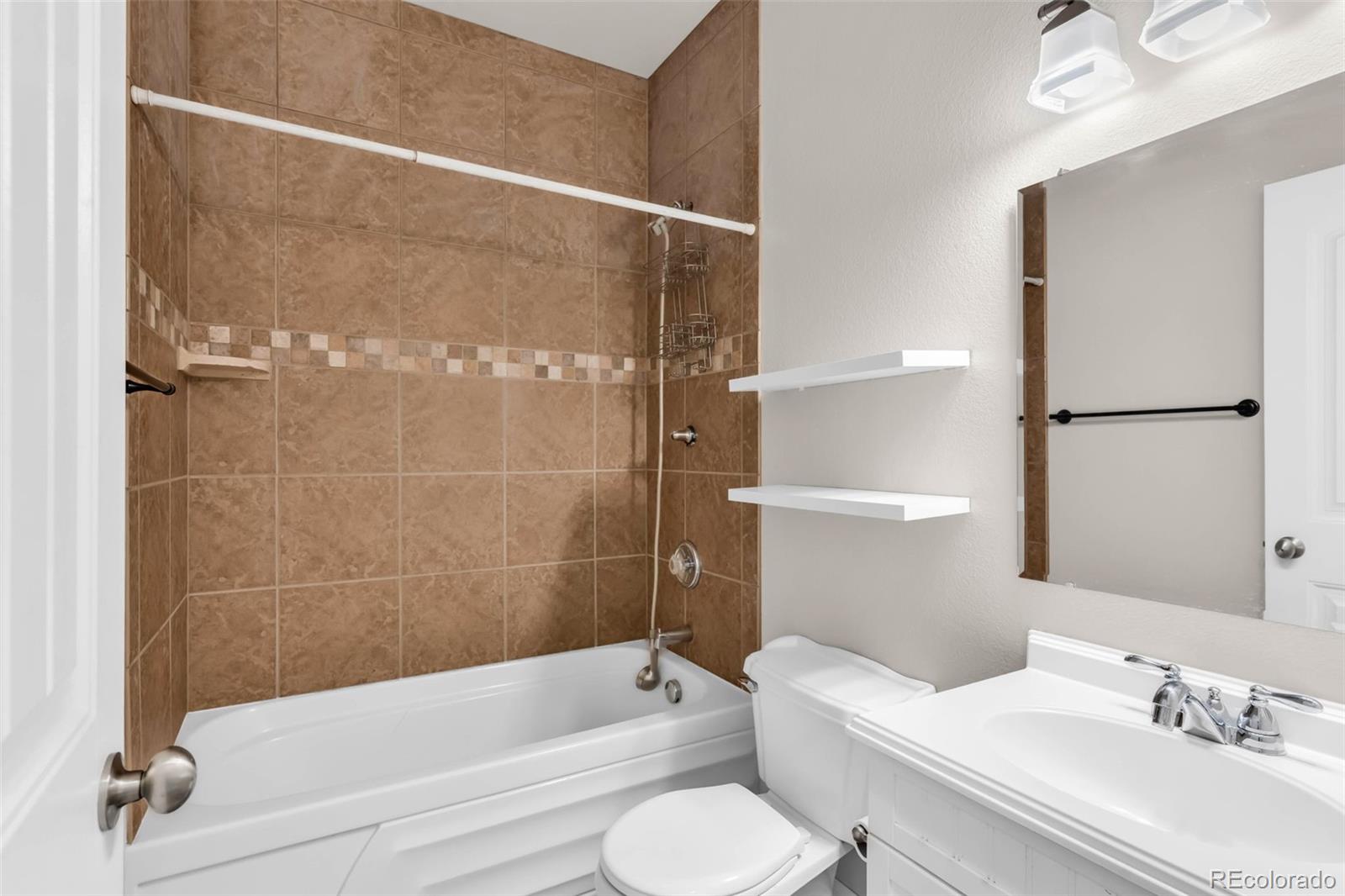 249 High Meadows Drive Florence, CO 81226 - Photo 16 of 47 a bathroom with a granite countertop bathtub shower sink vanity and toilet