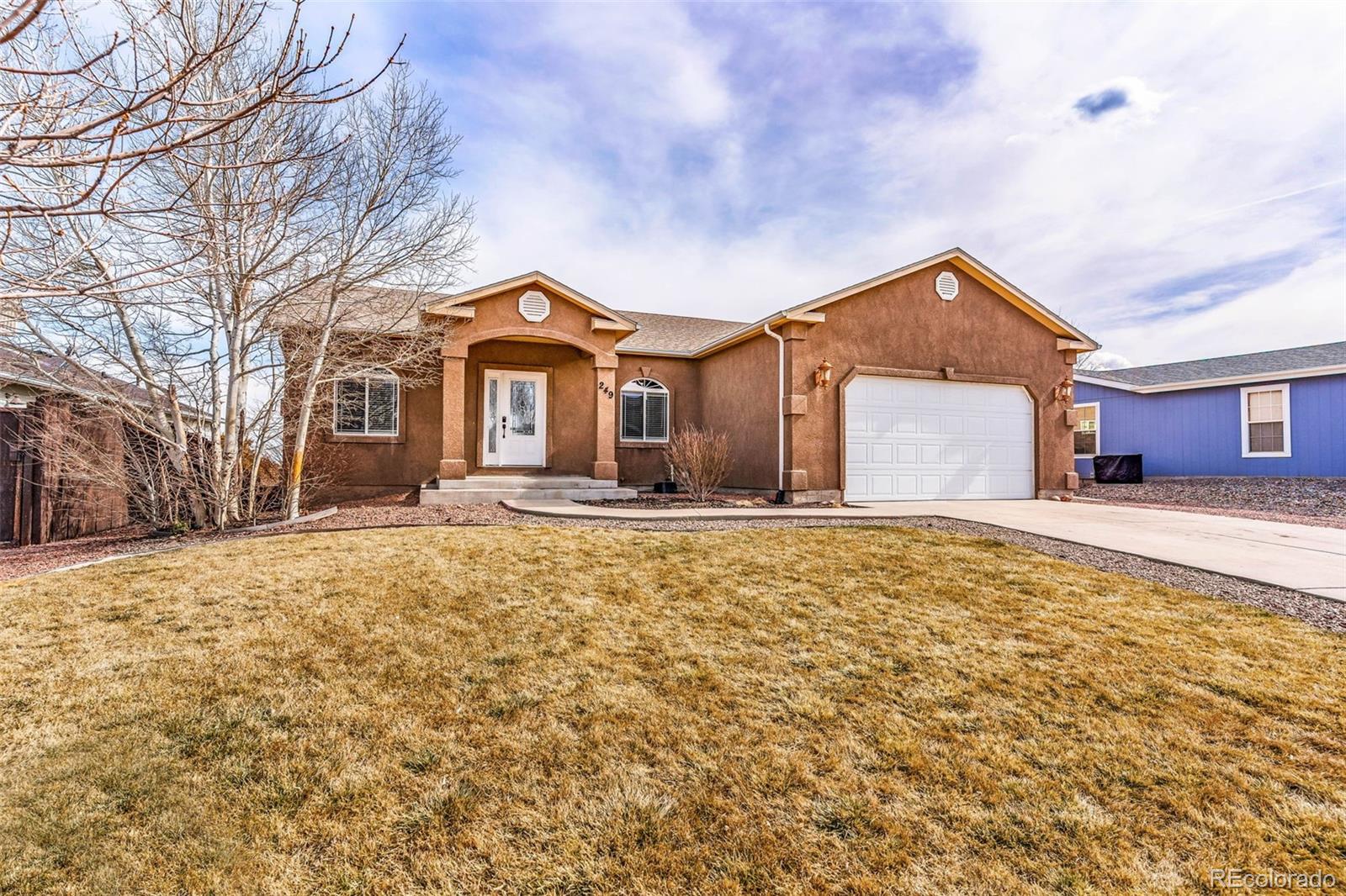 249 High Meadows Drive Florence, CO 81226 - Photo 2 of 47 a front view of a house with a yard