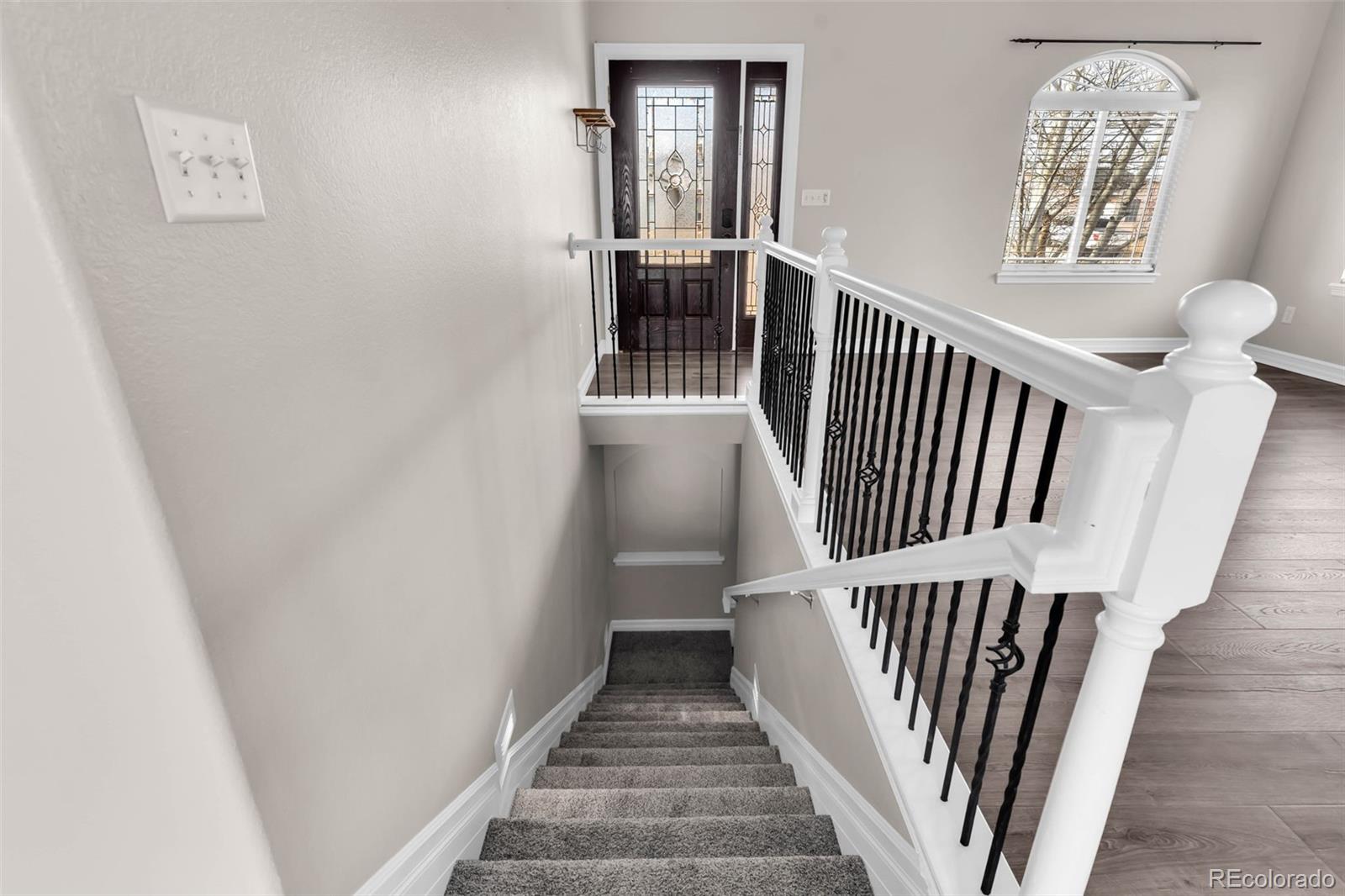 249 High Meadows Drive Florence, CO 81226 - Photo 25 of 47 a view of entryway with stairs and wooden floor