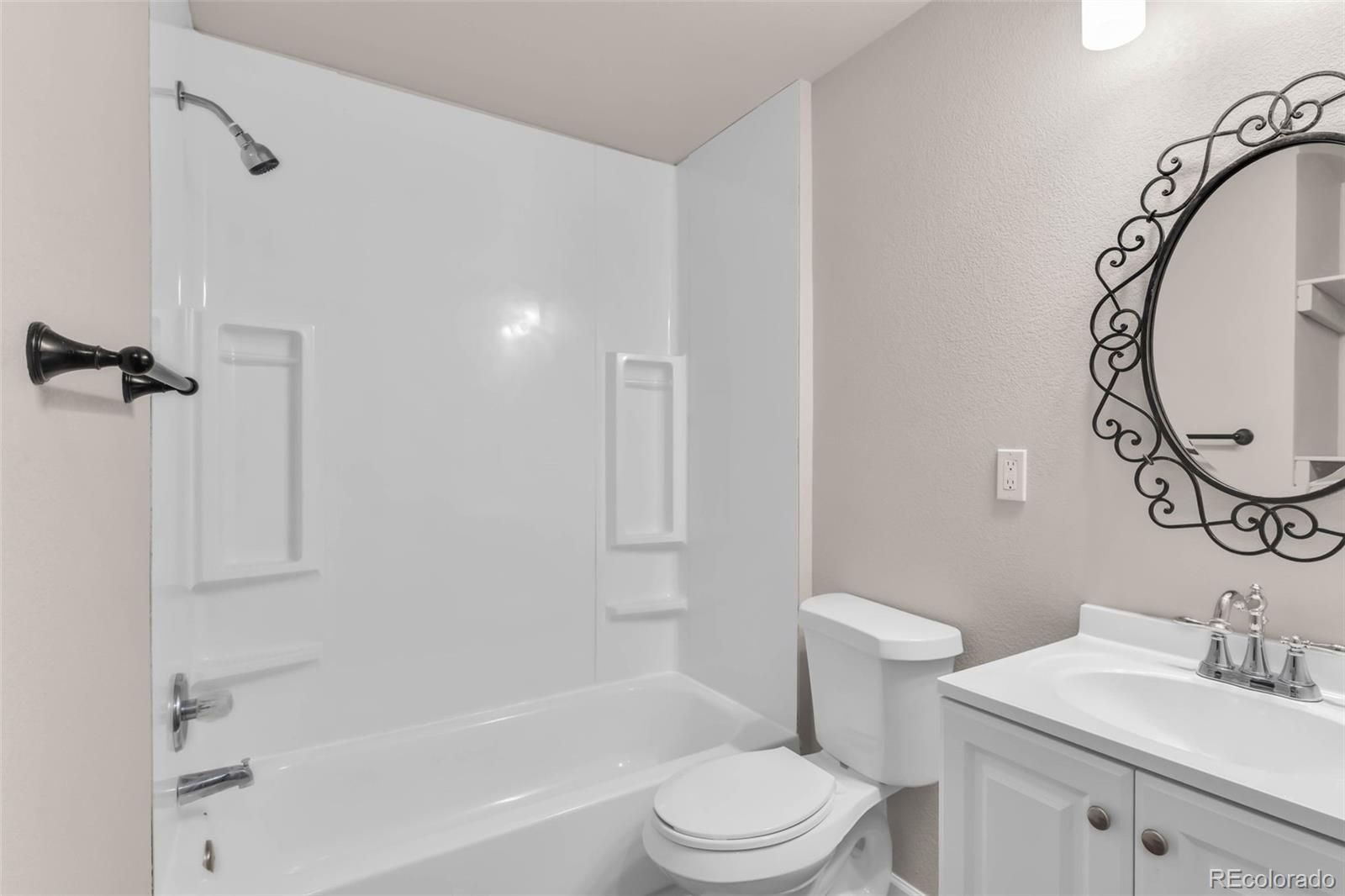 249 High Meadows Drive Florence, CO 81226 - Photo 33 of 47 a bathroom with a toilet sink vanity tub and shower