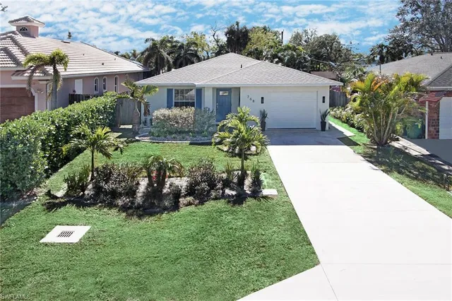 a aerial view of a house with a yard and plants
