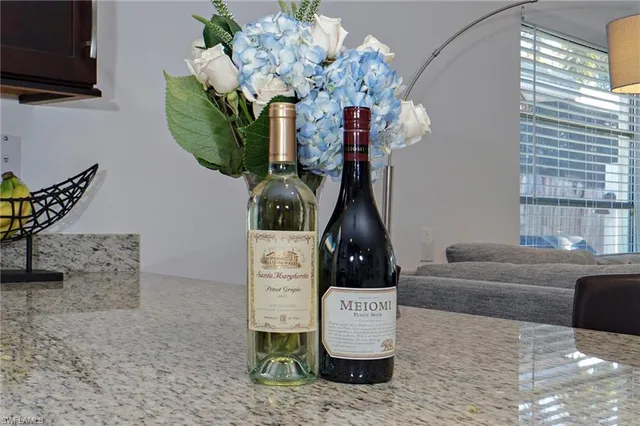 a living room with furniture a chandelier and a flat screen tv