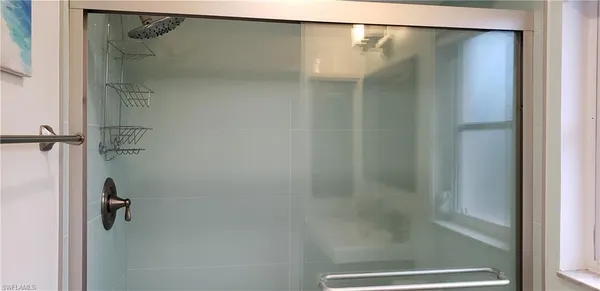 a bathroom with a glass shower door