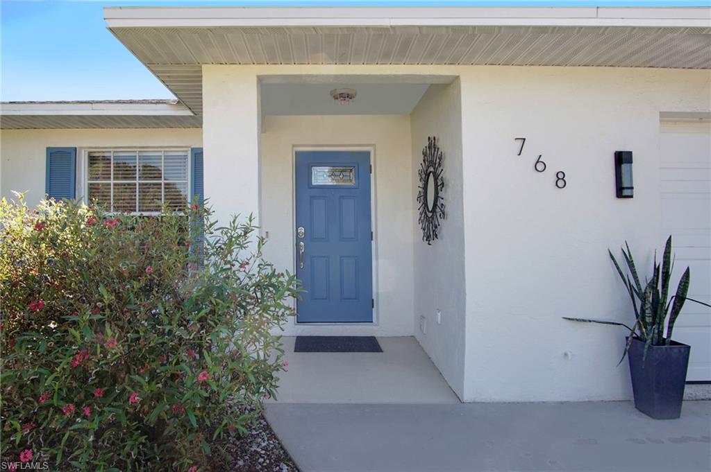 768 96th Avenue North Naples, FL 34108 - Photo 2 of 34 front view of a house with potted plants