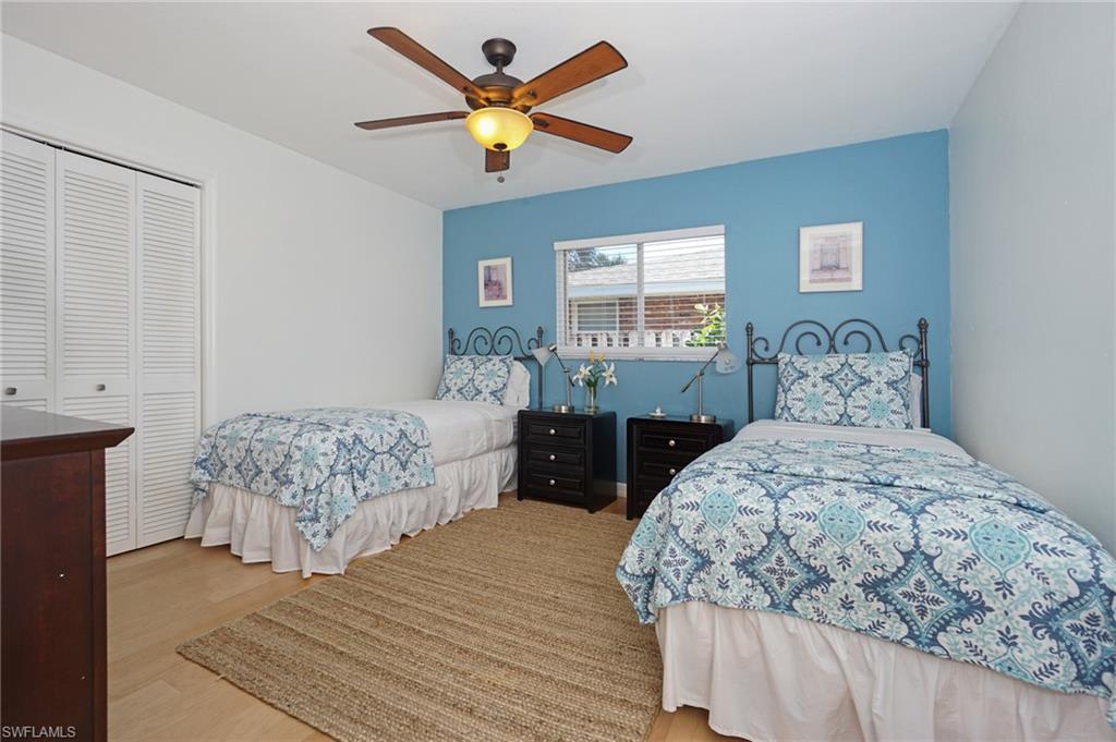 768 96th Avenue North Naples, FL 34108 - Photo 21 of 34 a bedroom with a bed and a chandelier