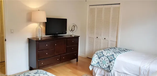 a bedroom with a bed and a flat screen tv