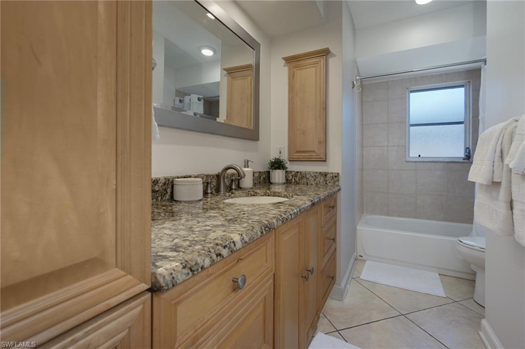 768 96th Avenue North Naples, FL 34108 - Photo 23 of 34 a bathroom with a granite countertop sink a toilet and shower