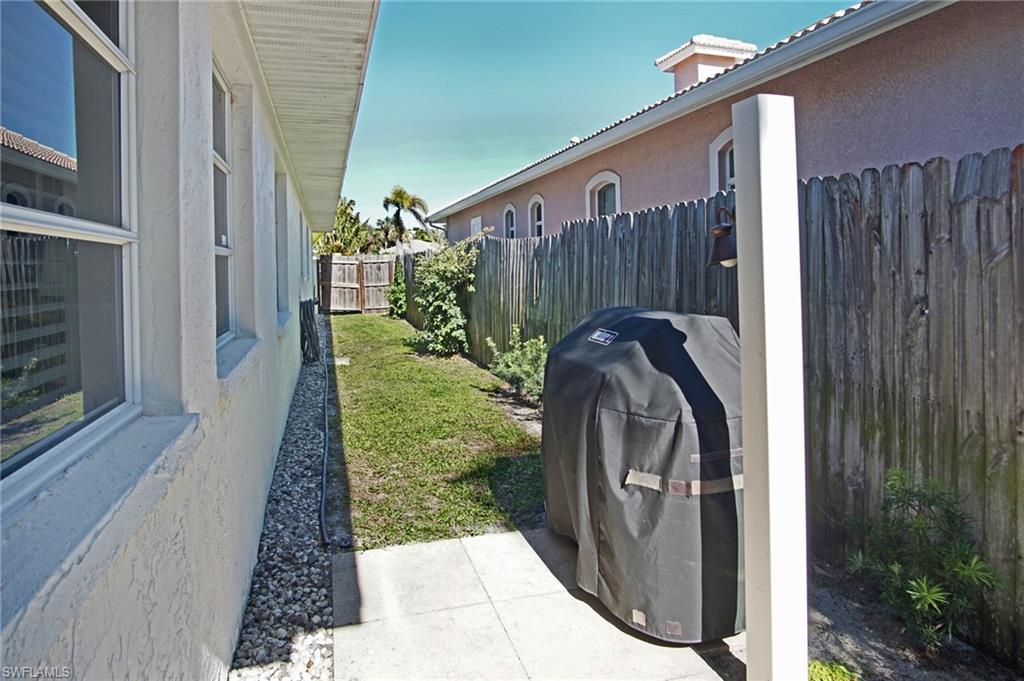 768 96th Avenue North Naples, FL 34108 - Photo 33 of 34 a front view of a house with garden