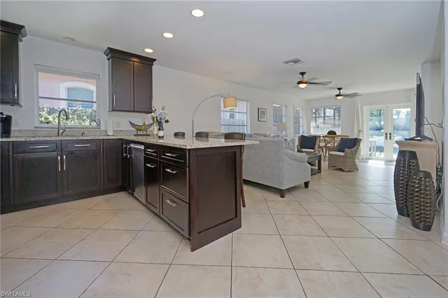 a large kitchen with kitchen island granite countertop a large counter top and stainless steel appliances