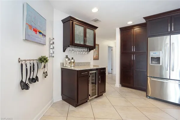 a kitchen with stainless steel appliances granite countertop a refrigerator and a sink