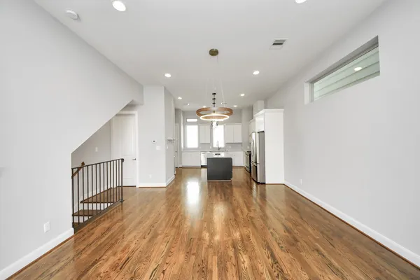 a kitchen with a table a sink and cabinets