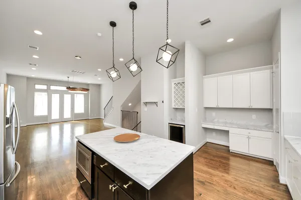 a kitchen with a sink kitchen island and stainless steel appliances