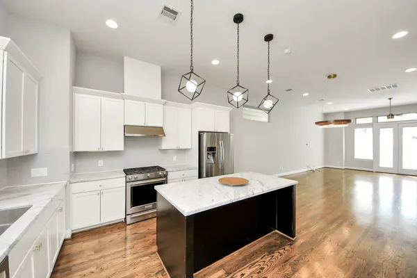 a kitchen with a sink stainless steel appliances and cabinets