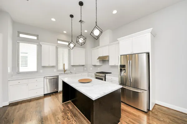 a kitchen with a stove a sink and a refrigerator
