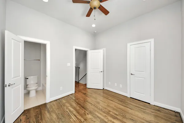 a bathroom with a granite countertop sink mirror vanity and toilet