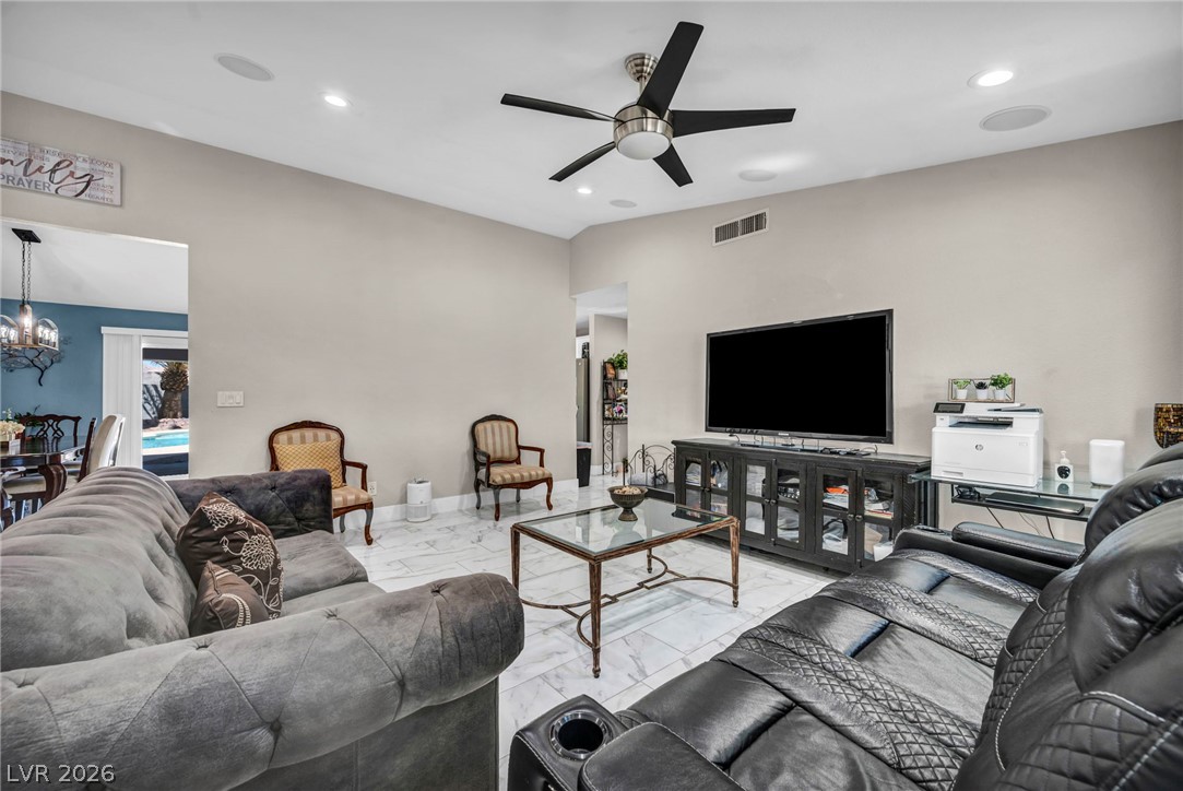5882 Rio Tinto Way Las Vegas, NV 89110 - Photo 37 of 56 Relax in this living area featuring a ceiling fan and elegant tiled flooring.