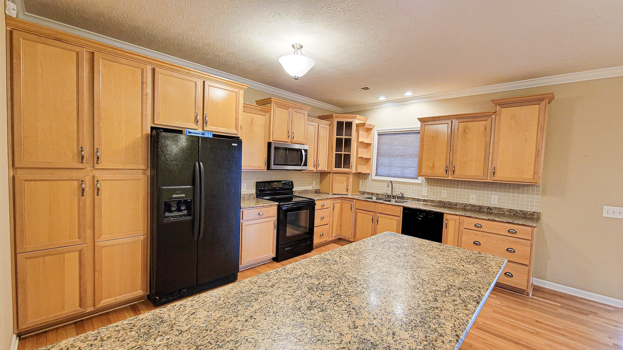 4200 Sandy Springs Road Springfield, TN 37172 - Photo 20 of 34 a kitchen with granite countertop cabinets stainless steel appliances and a window