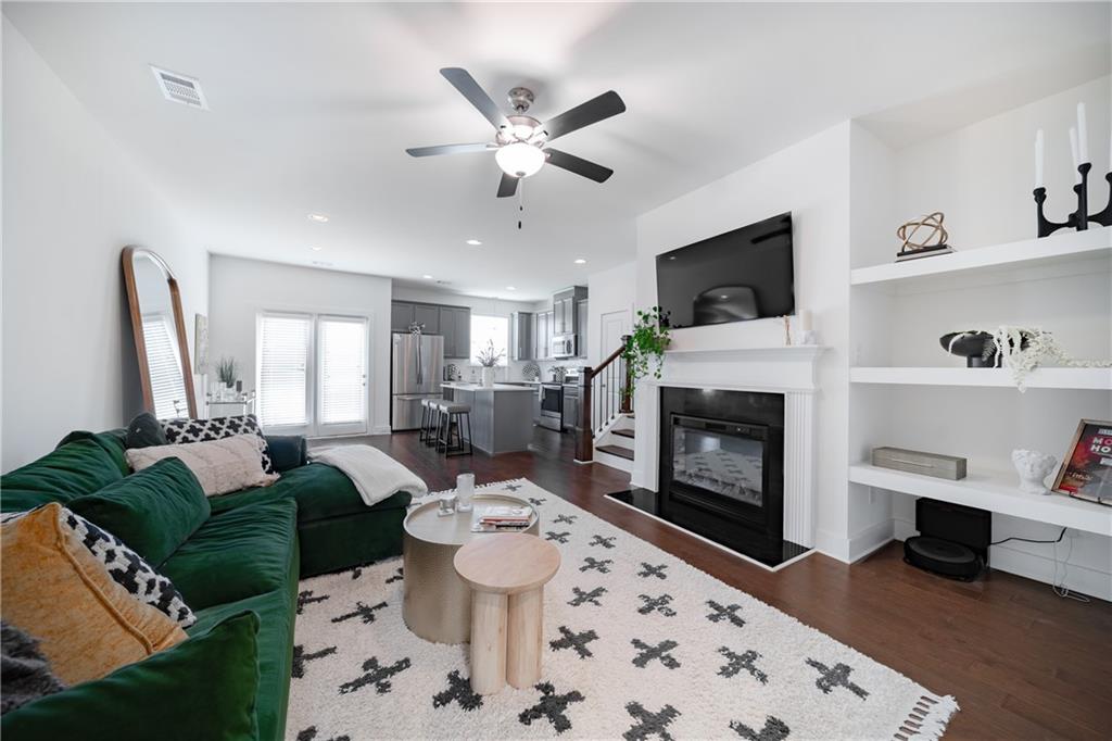 6350 Princeton Ridge Drive Lithonia, GA 30058 - Photo 12 of 45 a living room with furniture a fireplace and a flat screen tv