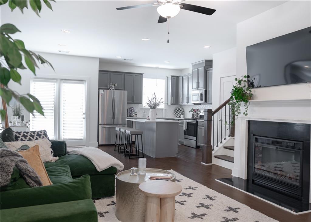 6350 Princeton Ridge Drive Lithonia, GA 30058 - Photo 13 of 45 a living room with furniture a fireplace and a chandelier