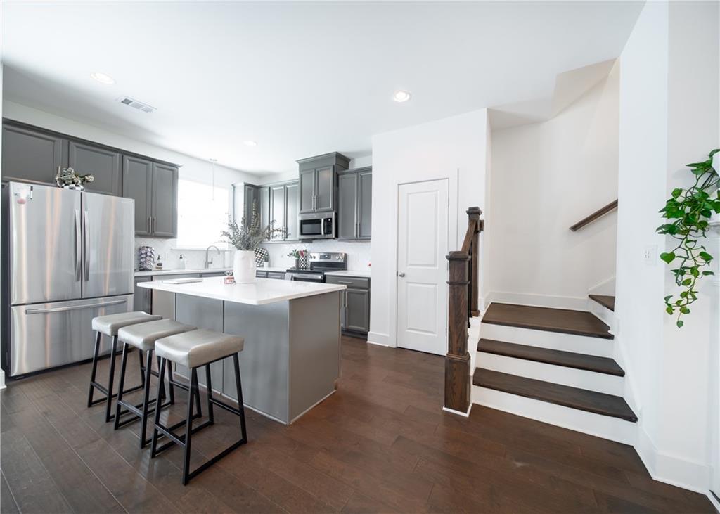 6350 Princeton Ridge Drive Lithonia, GA 30058 - Photo 14 of 45 a kitchen with a refrigerator a stove a microwave and furniture