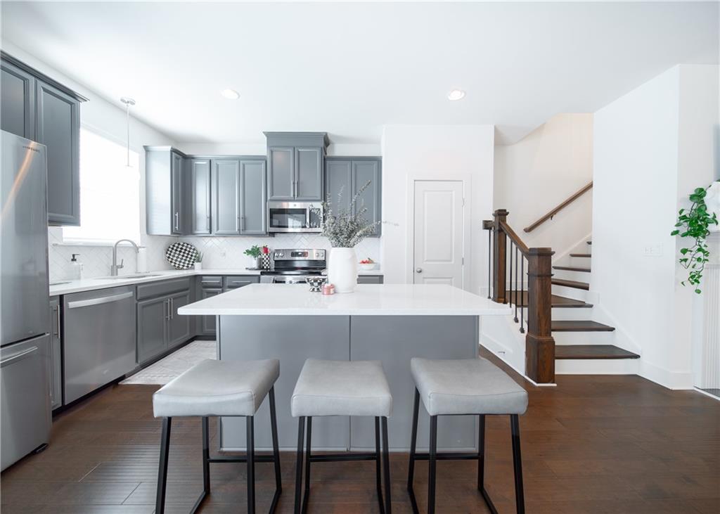 6350 Princeton Ridge Drive Lithonia, GA 30058 - Photo 15 of 45 a kitchen with kitchen island a sink table and chairs