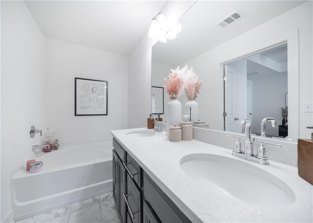 6350 Princeton Ridge Drive Lithonia, GA 30058 - Photo 31 of 45 a bathroom with a tub sink and mirror