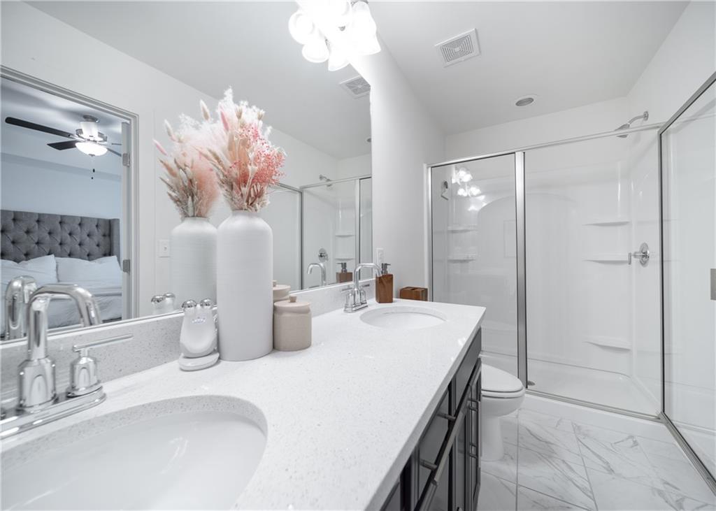 6350 Princeton Ridge Drive Lithonia, GA 30058 - Photo 33 of 45 a bathroom with a double vanity sink a mirror and a shower