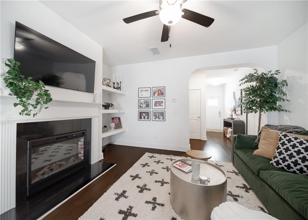 6350 Princeton Ridge Drive Lithonia, GA 30058 - Photo 9 of 45 a living room with furniture a flat screen tv and a fireplace