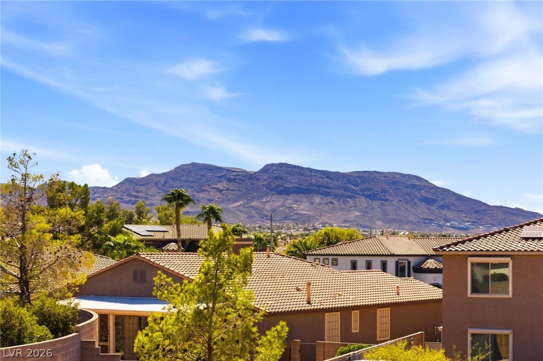 904 Shadowfax Road Henderson, NV 89015 - Photo 29 of 31 Dramatic mountain vistas rise above the surrounding neighborhood tile rooftops under clear desert skies.