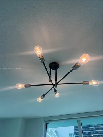 a kitchen with a sink a table and chairs