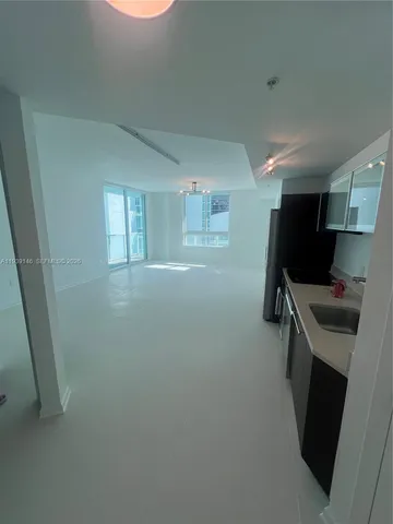 a kitchen with a refrigerator and a stove